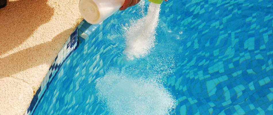 Adding chlorine to a pool in Cary, NC.
