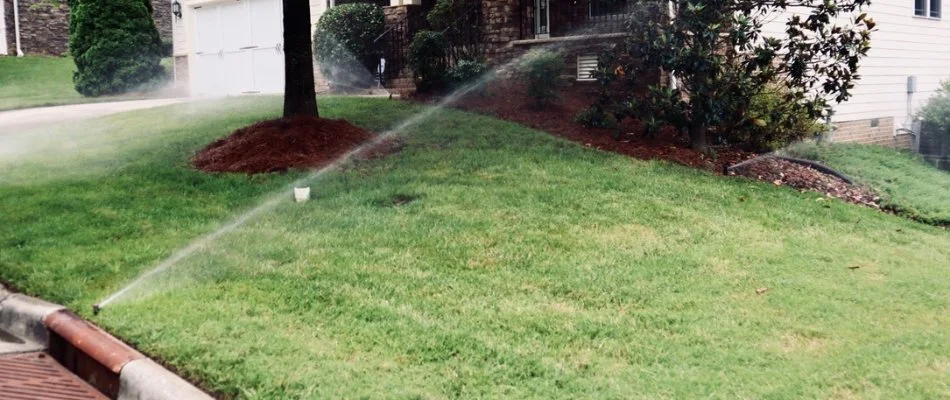 Sprinkler head watering a lawn in Cary, NC.