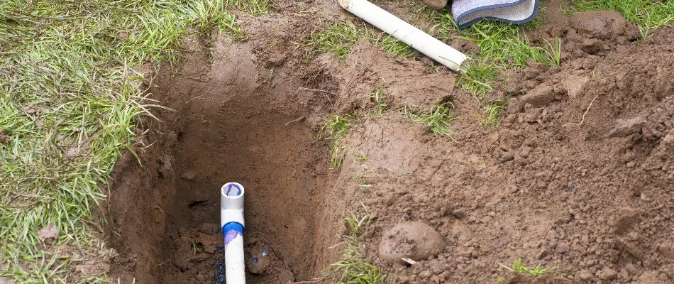 Trench with pipe on a lawn in Cary, NC.