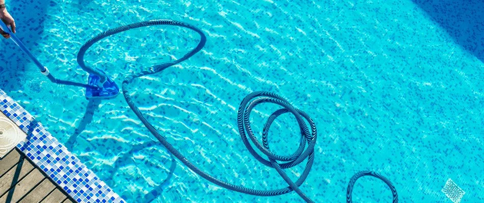 Vacuuming the bottom surface of a pool in Cary, NC.