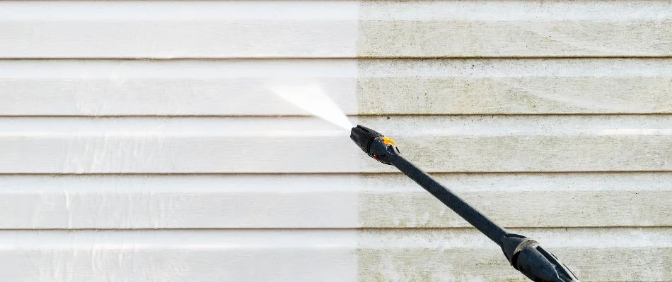 Pressure washing the side of a house in Clayton, NC.