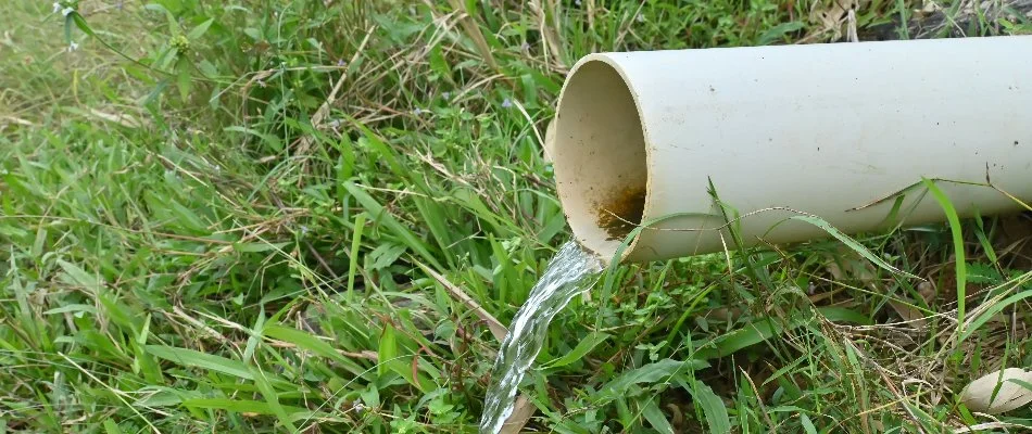 White drainage pipe with surrounding grass in Cary, NC.